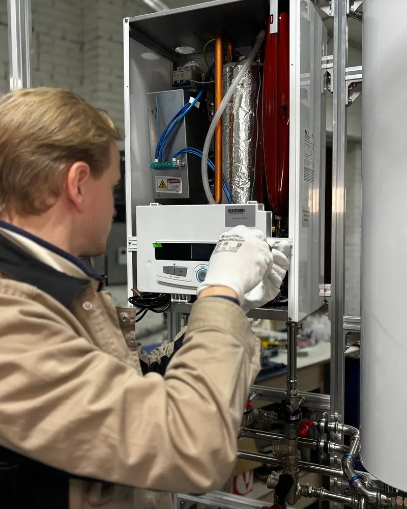 Heating engineer at work on a boiler