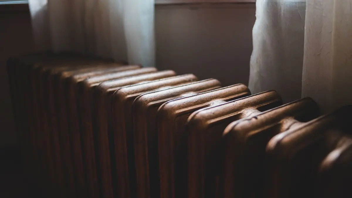 Old cast iron column radiator in a dim room