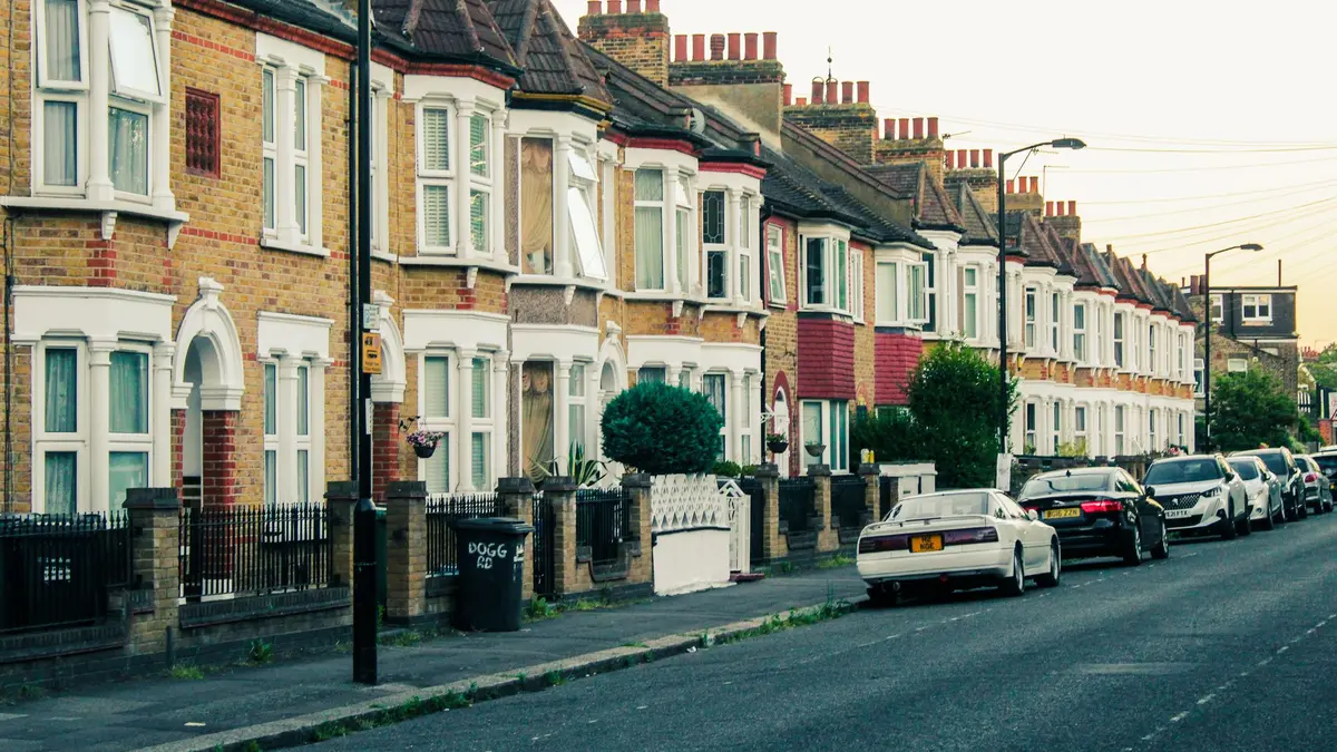 Street of terraced houses in south London with parked cars
