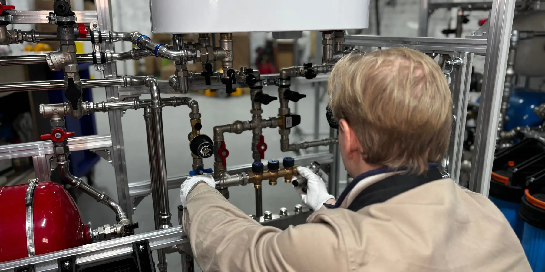 Engineer adjusting heating pipework
