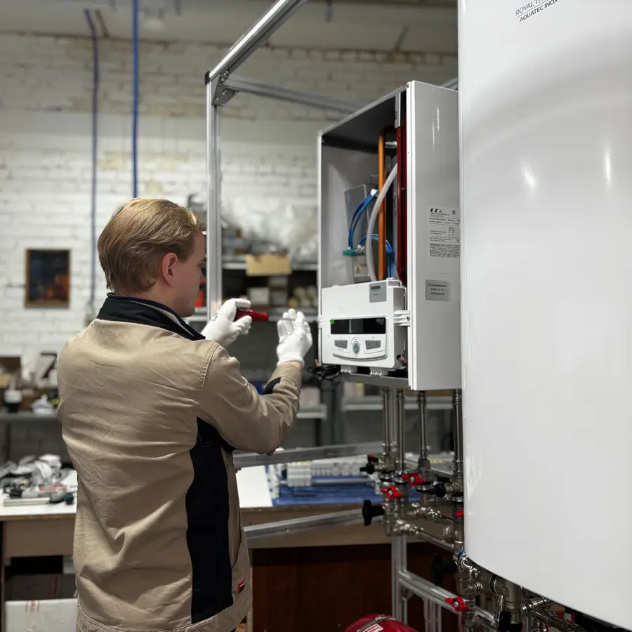 Engineer checking a wall-hung boiler
