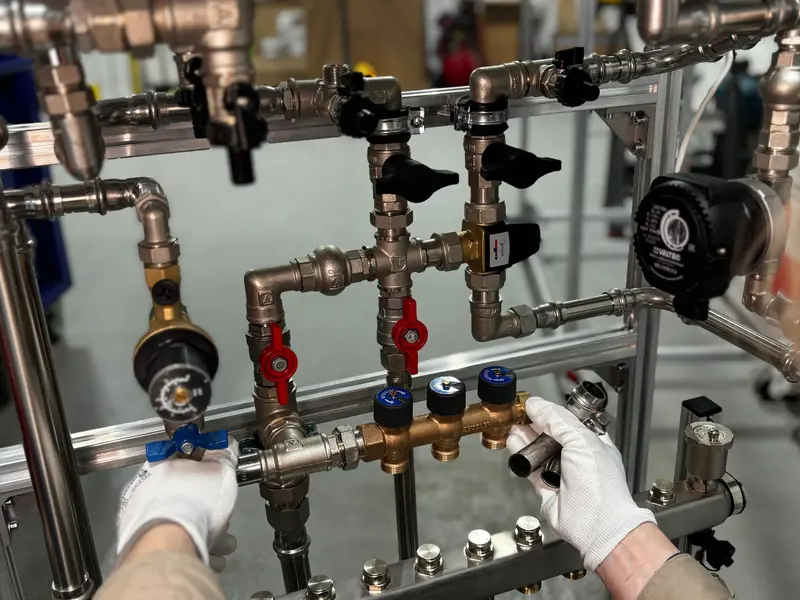 Engineer working on heating pipework